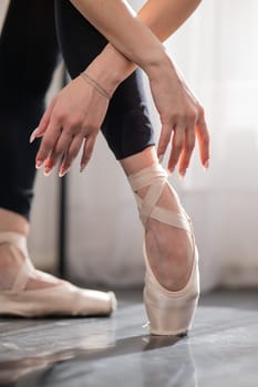 Close-up of the legs and arms of a ballerina.