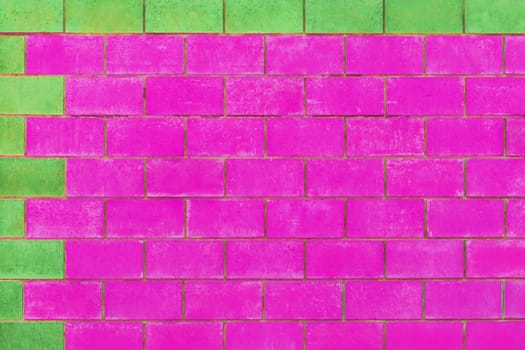 Green and purple pink paint on brick blocks urban color vibrant design wall texture background architecture