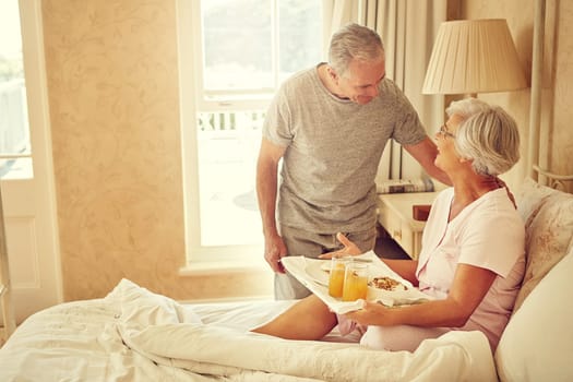 Bringing breakfast to his beloved. a senior man bringing breakfast in bed to his wife.