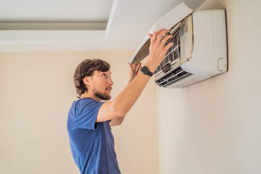 technician service removing air filter of the air conditioner for cleaning