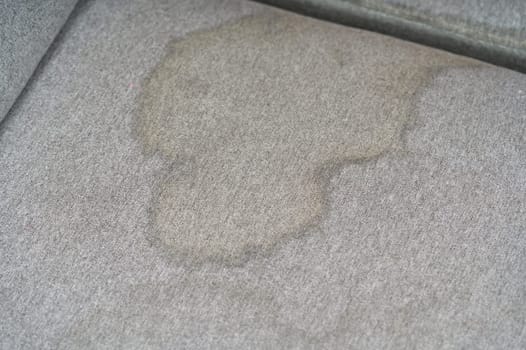 Dirty, stain, blot, fleck of water on the fabric, textile sofa. Dirty textile sofa chemical cleaning