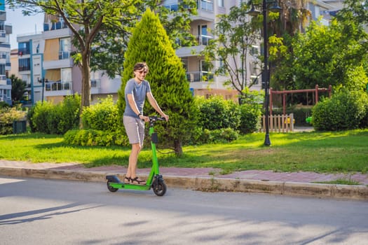 Young man riding electric scooter in urban background. Electric scooters for rent