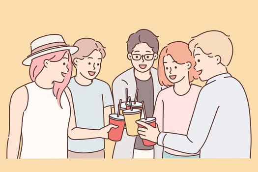 Group of young guys and girls drink drinks during holiday party from disposable cups with straw