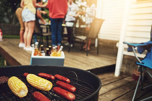 Its the weekend, time to get your grill on. a group of friends having a barbecue in the yard