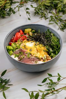 Portion of poke bowl with beef pastrami vegetables