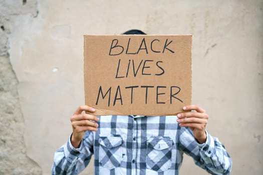 Man holding cardboard with the inscription, black life has value.