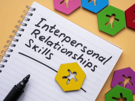 Page with inscription Interpersonal Relationships skills and figurines.