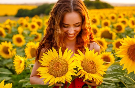 Cute young woman is holding sunflower in her hand while
