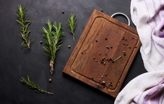 Sprigs of fresh rosemary on a black background, top view