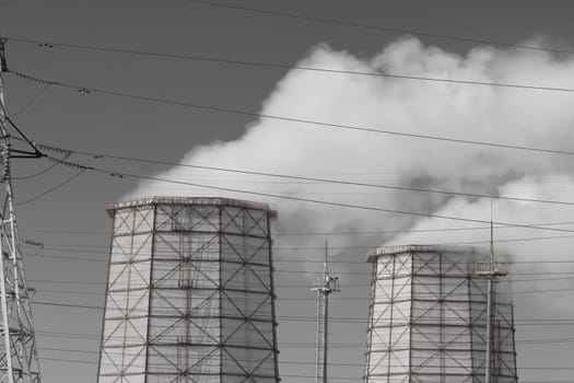 Toxic grey smoke is released from the cooling tower into the atmosphere and pollutes the environment, air and atmosphere. Operation of the industrial heat and power plant