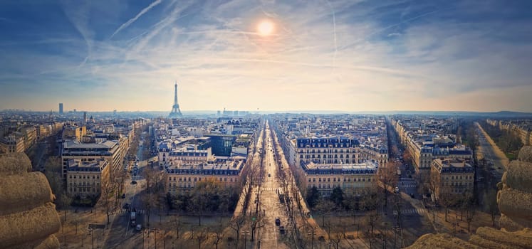Wide angle Paris cityscape panorama with view to the Eiffel Tower, France. Beautiful parisian architecture with historic buildings, landmarks and busy city streets