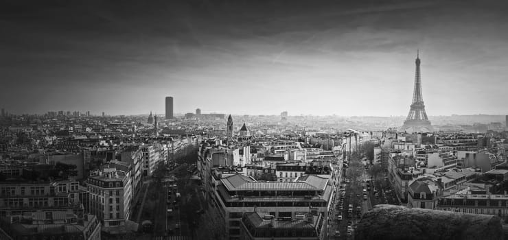 Black and white Paris panorama. Romantic aerial view over rooftops to the Eiffel Tower, France. Holiday destination, sightseeing parisian cityscape scene, historic landmarks on the horizon