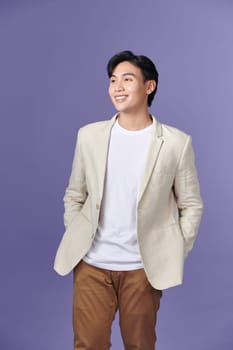 portrait of asian young smiling man standing on white background