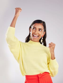Winner, happy and celebration with a woman on a white background in studio cheering for success or good news. Motivation, wow and excited with an attractive young female celebrating or winning.