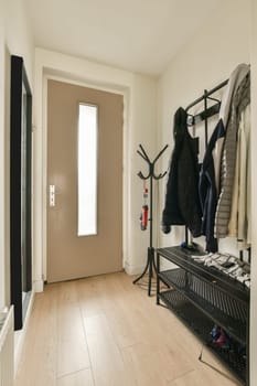 a hallway with a coat rack and a door to