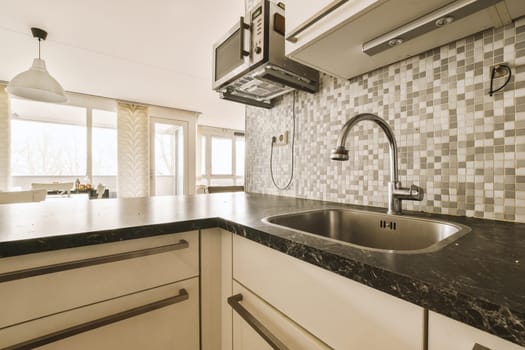 a kitchen counter with a sink and a fauc