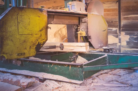 Sawmill. Process of machining logs in sawmill machine saws the tree trunk