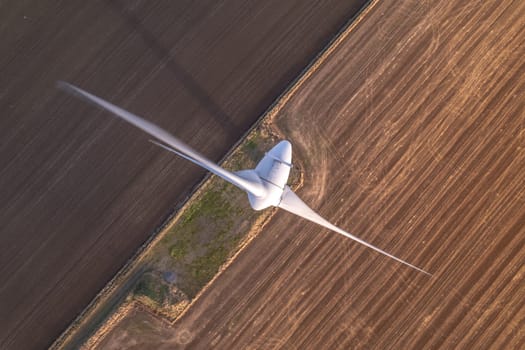 Aerial View of a Renewable Energy Wind Turbine on a Sunny Day