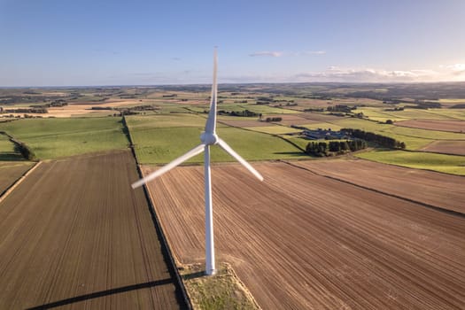A Solitary Wind Turbine on a Green Renewable Energy Farm on a Sunny Day