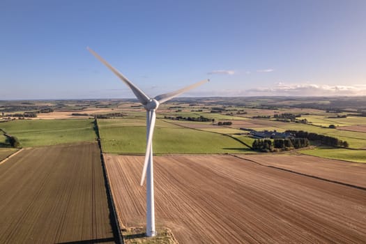 A Wind Turbine on a Green Renewable Energy Farm on a Sunny Day