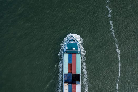 A bulk carrier container ship seen from a bird's eye view crossing the ocean