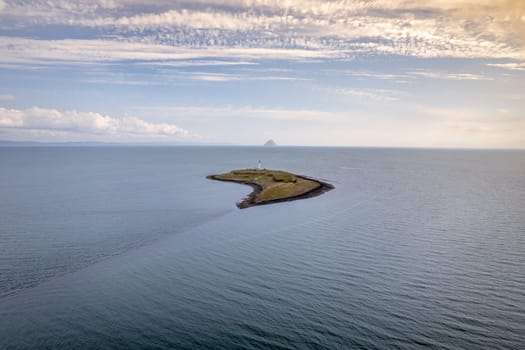 The Island of Pladda off the South Coast of Arran in Scotland with a Lighthouse