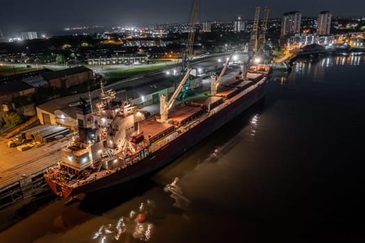 A Transport Ship Docked at Night Awaiting Cargo Loading