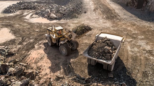 A Digger and Dump Truck Working in a Quarry For Mining