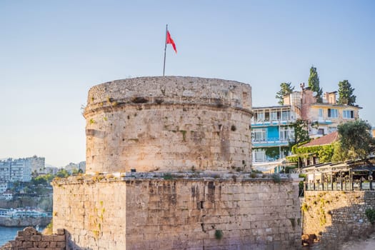 The Hidirlik Tower in Antalya against the backdrop of the Mediterranean bay of the ancient Kaleici district, Turkey. Turkiye