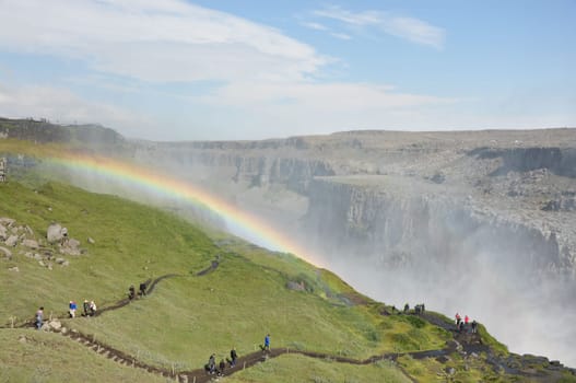 Colorful rainbow over the Dettifoss waterfall in the northeast of Iceland