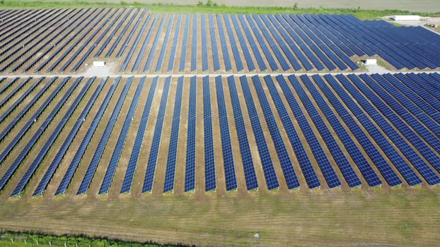Solar power plant. Many blue panels of large solar power plant Aerial drone view