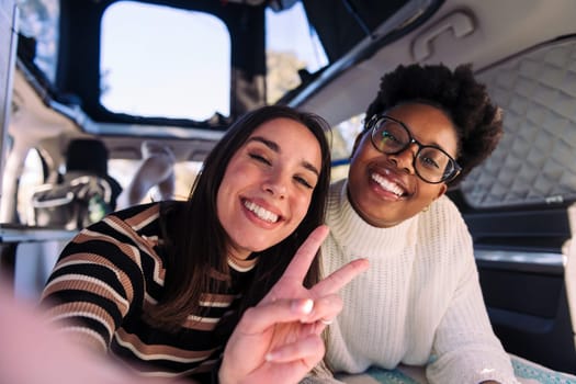 selfie photo of two women having fun in camper van