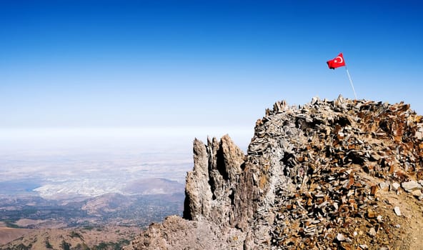 National flag of Turkey on volcano top