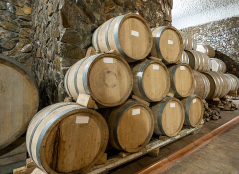 The wooden wine barrels in a wine factory