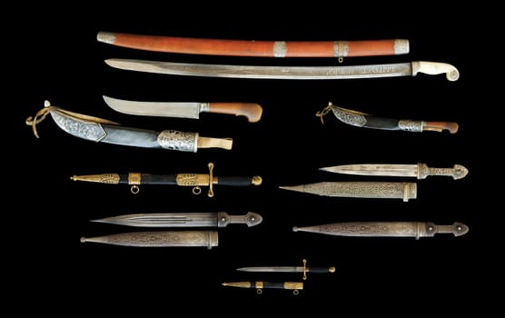 The Set of antique knives and daggers isolated on a black background, Central Asian, Uzbekistan