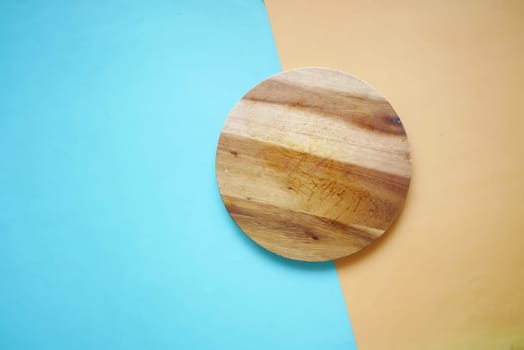 wooden chopping board on black background top down
