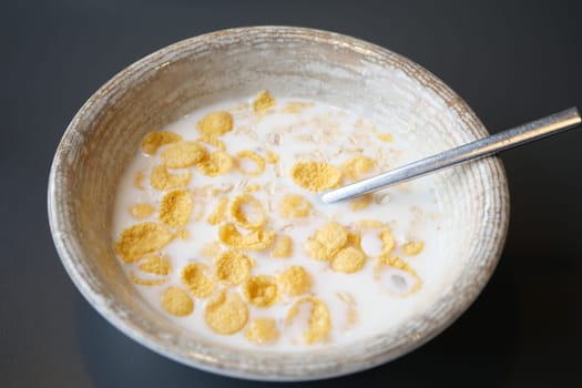 corn flakes cereal with milk on table