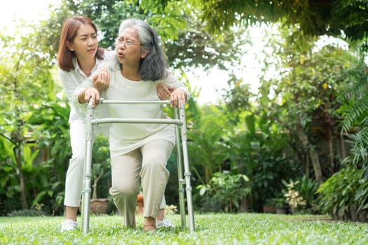 Asian senior woman falling down at home in the backyard caused by myasthenia (Muscle Weakness) and the daughter came to help support. Concept of old elderly insurance and health care