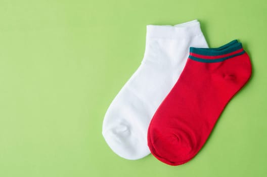The red and white color Socks on green background.
