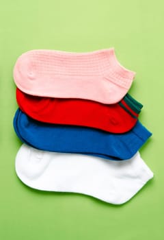 The Socks of different colors on yellow color background.