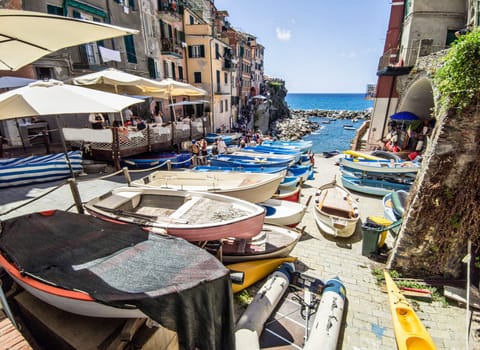 Ligurian town of Manarola with tourists and moored boats