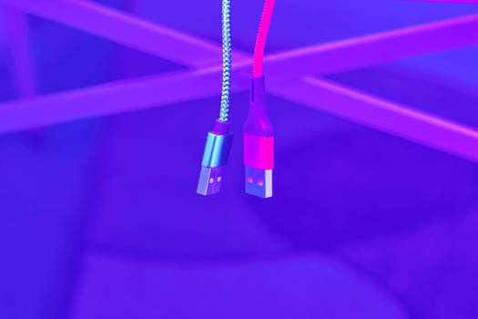 Connect and chat. Blue and red usb cables on pale purple background
