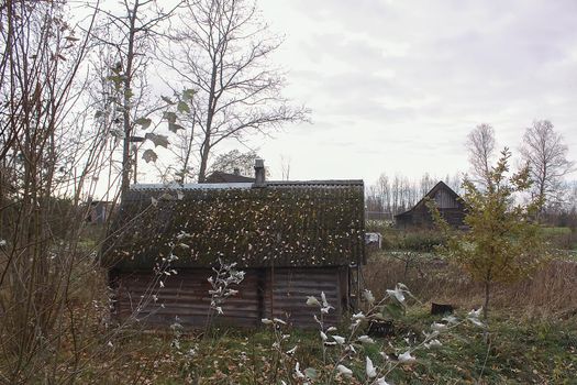Old wooden building of bathhouse in the village. Traditional exterior oin Russian style.