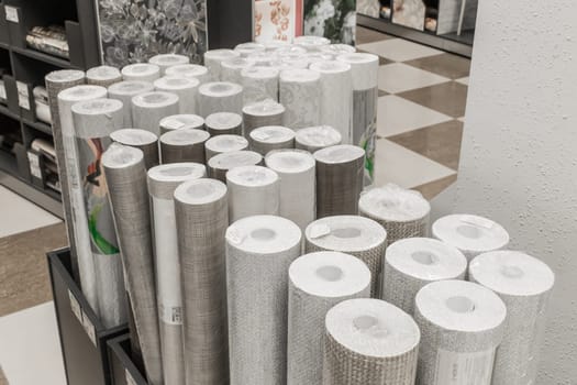 A bunch of light rolls of wallpaper paper in the hardware store materials for repair