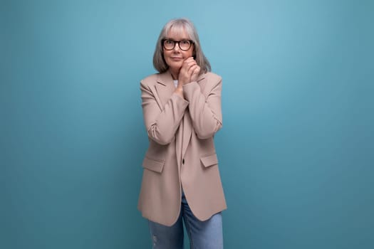 portrait of a hopeful middle-aged woman in a business outfit on a studio background with copy space