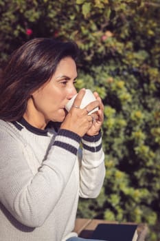 Taking a Break Latina Woman Drinking Coffee in the Garden