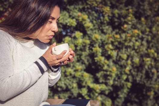 Disconnecting, Latina Woman Taking a Break with Coffee in the Garden