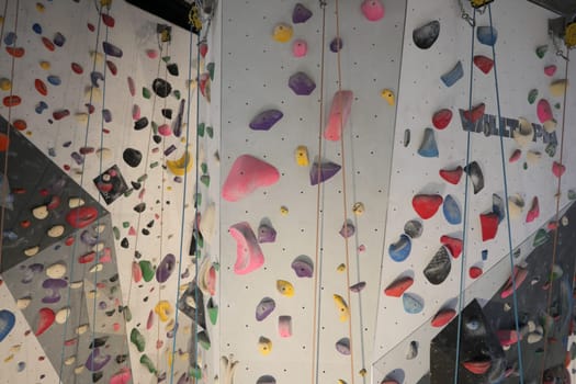 Artificial climbing wall with Colourful grip rocks.