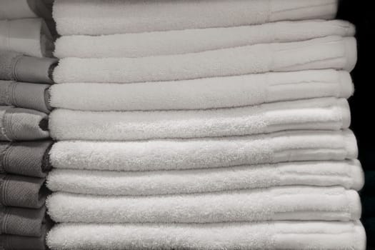Set pile stacked grey monochrome color fabric gray towels object hygiene bathroom concept, close up
