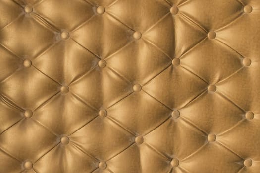 Gold leather upholstery sofa pattern button design furniture style decor texture background decoration vintage golden abstract